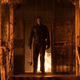 Michael Myers stands in a fiery inferno in a still from Halloween Kills.